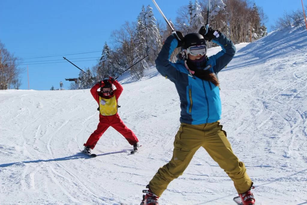 Ski instructor teaching a young skier